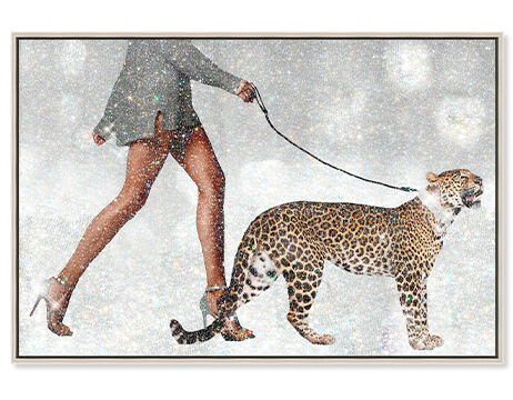 Framed canvas wall art of a woman walking a jaguar
