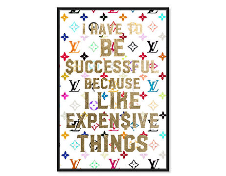 Framed motivational wall art with a quote about success and a colorful fashion monogram pattern in the background