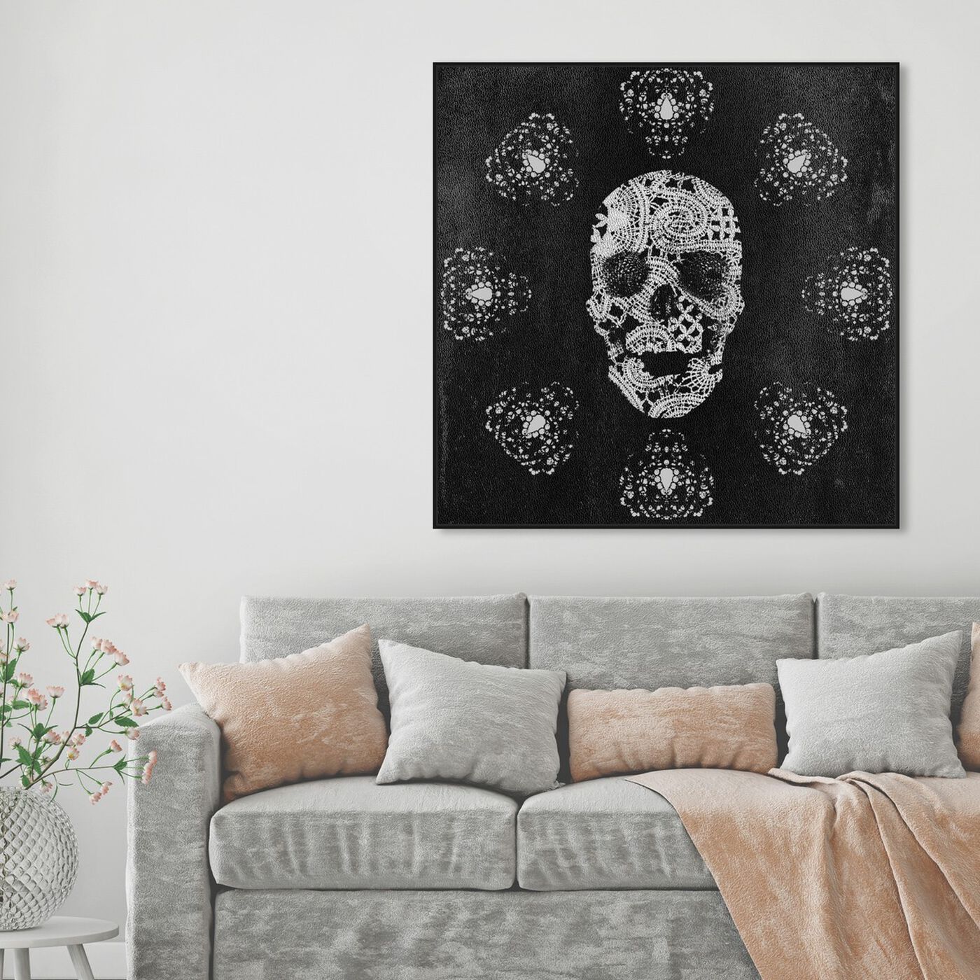 Hanging view of Lace and Leather featuring symbols and objects and skull art.